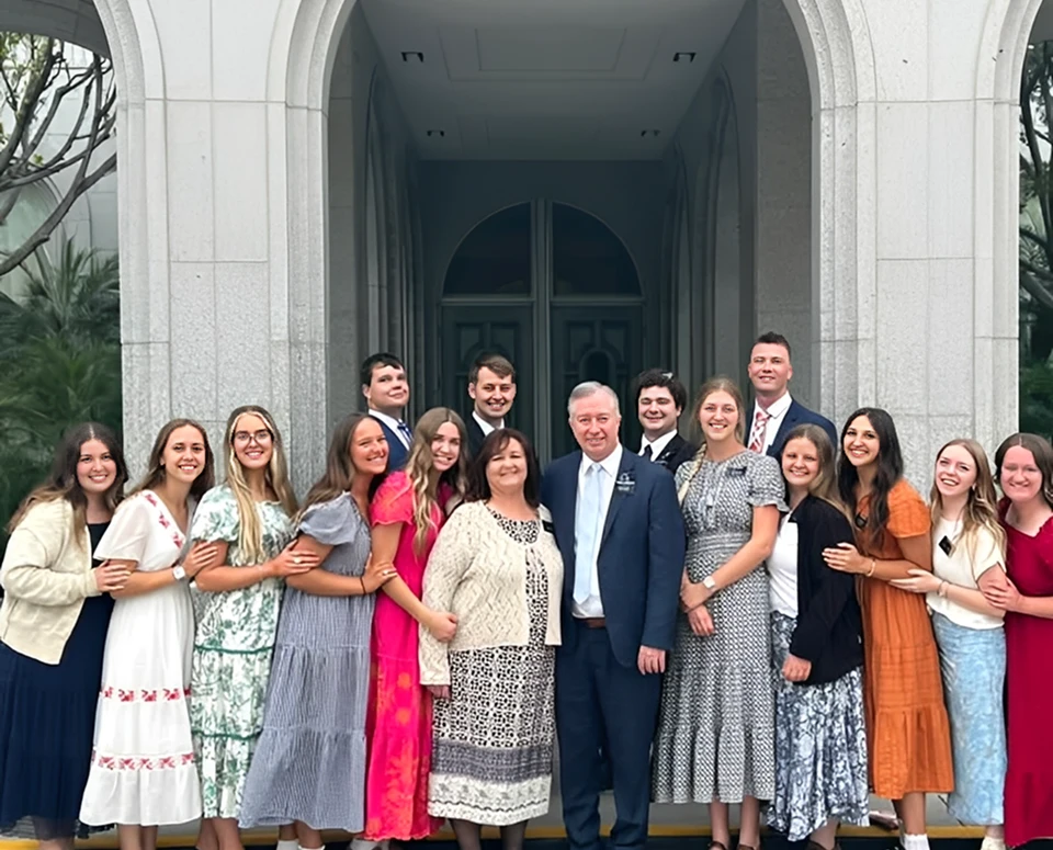 Group of people posing outside a building.